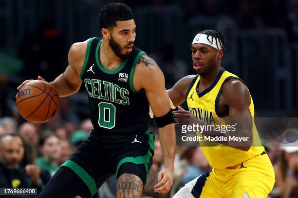 Buddy Hield of the Indiana Pacers defends Jayson Tatum of the Boston Celtics during the first quarter at TD Garden on November 01, 2023 in Boston,...
