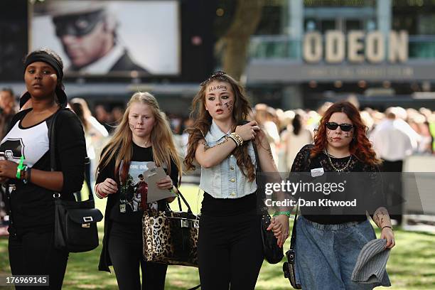 One Direction fans arrive to take their positions in Leicester Square ahead of the premier to the bands new film on August 20, 2013 in London,...