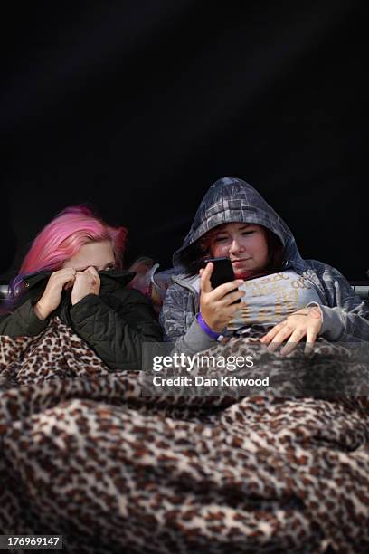 One Direction fans take their positions in Leicester Square ahead of the premier to the bands new film on August 20, 2013 in London, England. The...