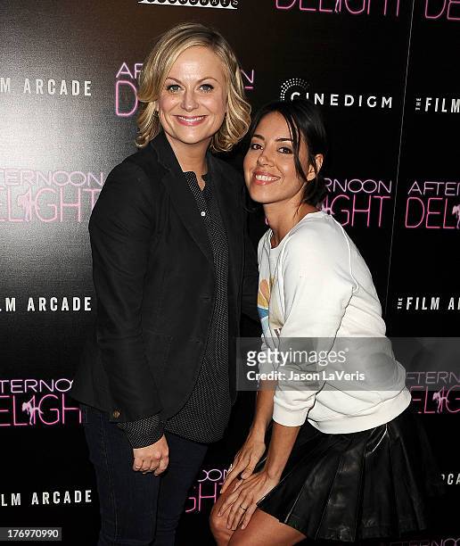 Actresses Amy Poehler and Aubrey Plaza attend the premiere of "Afternoon Delight" at ArcLight Hollywood on August 19, 2013 in Hollywood, California.