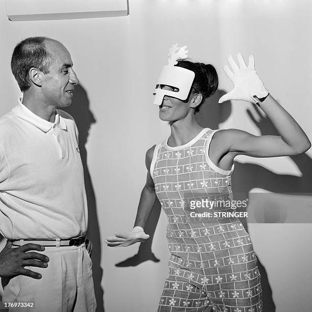 Photo taken on July 2, 1967 shows French fashion designer Andre Courreges and a model wearing a 1967/1968 haute couture collections creation. AFP...