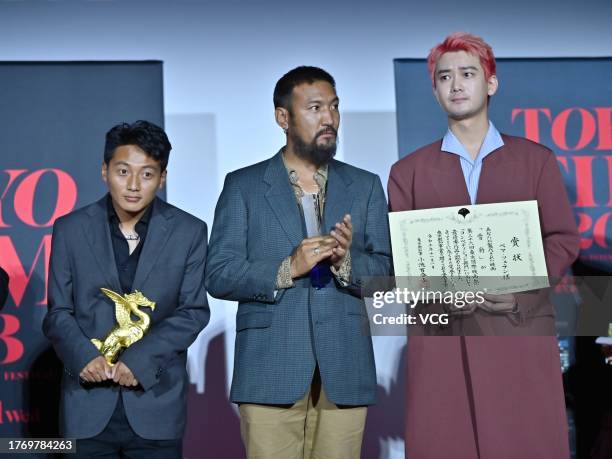 Actor Tseten Tashi, actor Jinpa and actor Xiaong Ziqi pose on the stage as the film 'Snow Leopard' is awarded the Grand Prix during the closing...