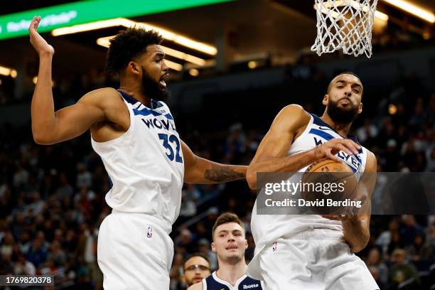 Rudy Gobert of the Minnesota Timberwolves rebounds the ball as Karl-Anthony Towns looks on in the third quarter against the Denver Nuggets at Target...