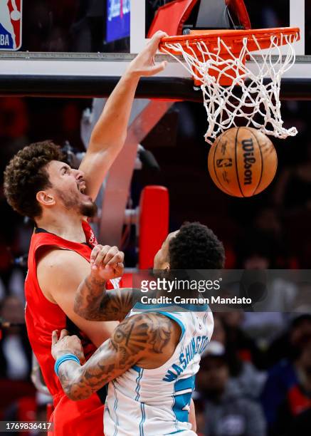 Alperen Sengun of the Houston Rockets dunks the bal over P.J. Washington of the Charlotte Hornets during the second half at Toyota Center on November...
