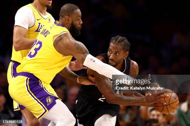Kawhi Leonard of the Los Angeles Clippers handles the ball against LeBron James of the Los Angeles Lakers during the second quarter at Crypto.com...