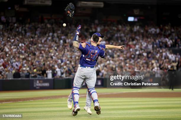 Jonah Heim and Josh Sborz of the Texas Rangers celebrate after beating the Arizona Diamondbacks 5-0 in Game Five to win the World Series at Chase...