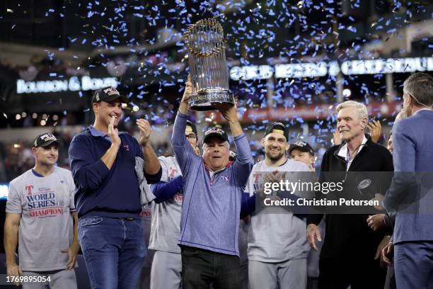 Texas Rangers President of Business Operations and CEO Neil Leibman hoists the Commissioner's Trophy after the Texas Rangers beat the Arizona...