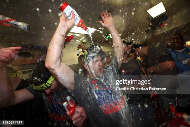 The Texas Rangers celebrate in the clubhouse after beating the Arizona Diamondbacks 5-0 in Game Five to win the World Series at Chase Field on...