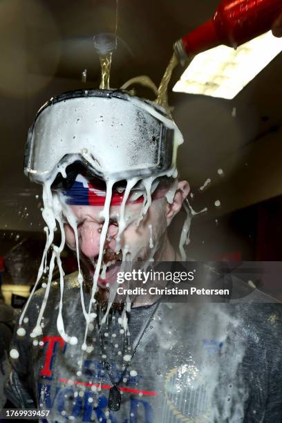 Jonah Heim of the Texas Rangers is dunked with beer in the clubhouse after the Texas Rangers beat the Arizona Diamondbacks 5-0 in Game Five to win...