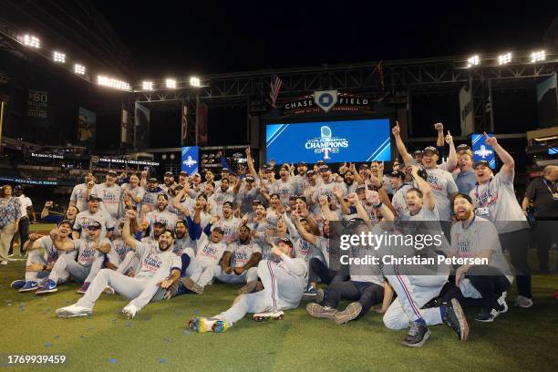 The Texas Rangers pose for photos after beating the Arizona Diamondbacks 5-0 in Game Five to win the World Series at Chase Field on November 01, 2023...