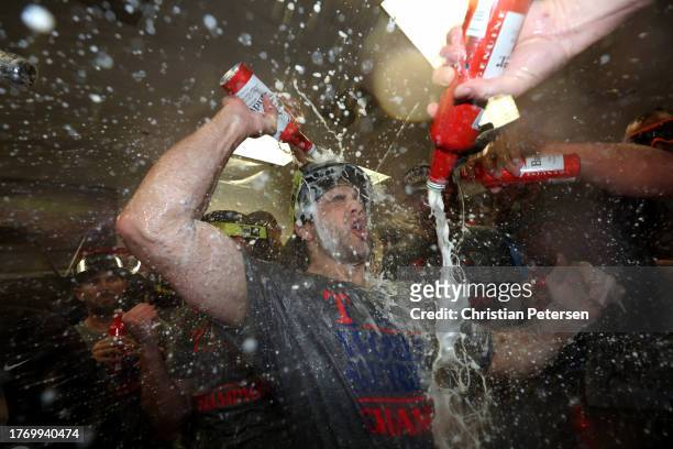 The Texas Rangers celebrate in the clubhouse after beating the Arizona Diamondbacks 5-0 in Game Five to win the World Series at Chase Field on...