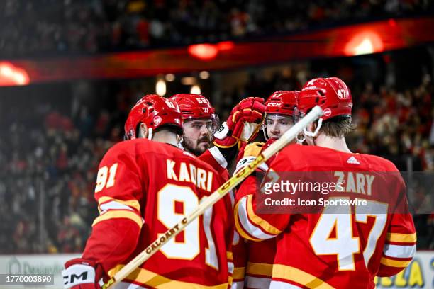 Calgary Flames Center Nazem Kadri celebrates a goal with Calgary Flames Defenceman MacKenzie Weegar , Calgary Flames Winger Yegor Sharangovich and...