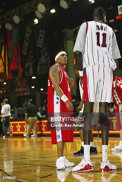 Musician Nelly talks to former NBA star Manute Bol during the Celebrity Game at the NBA Jam Session at the Georgia World Congress Center on February...