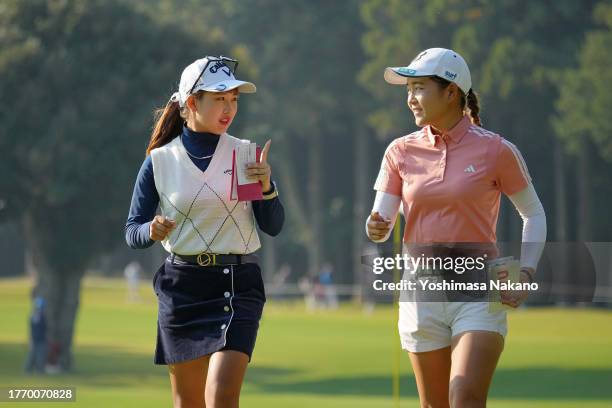 Hana Lee of South Korea and Miyu Sato of Japan talk after holing out on the 9th green during the first round of the TOTO Japan Classic at the...