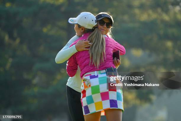 Shiho Kuwaki of Japan and Emily Pedersen of Denmark embra after holing out on the 9th green during the first round of the TOTO Japan Classic at the...