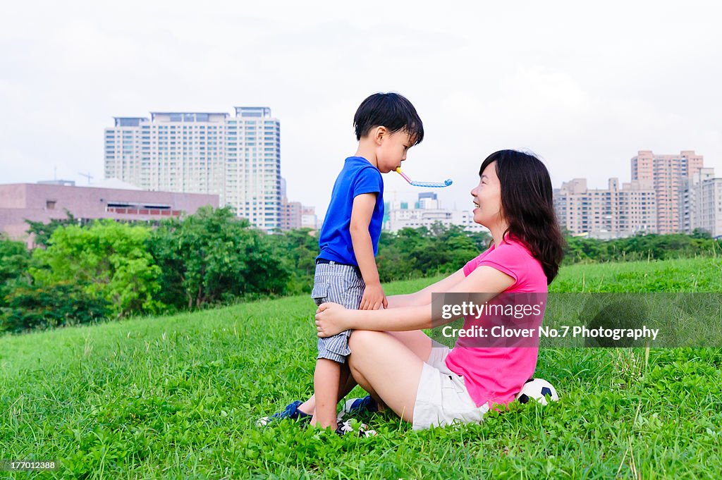 Asian mother and son playing game.