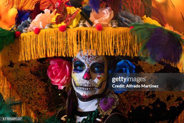 Woman poses for a portrait dressed as 'La Catrina', a character created by the Mexican engraver and illustrator Jose Guadalupe Posada, during 'Day of...