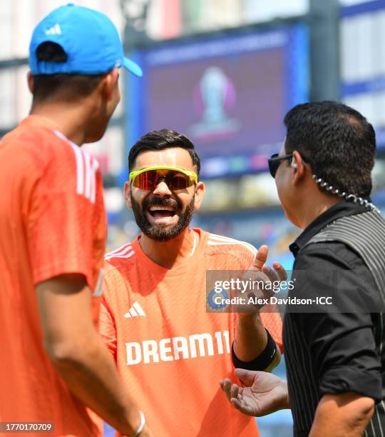 Virat Kohli and Shubman Gill of India interact with Piyush Chawla ahead of the ICC Men's Cricket World Cup India 2023 between India and Sri Lanka at...