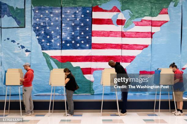 Voters fill out their ballots at a polling station on Tuesday, November 7, 2023.