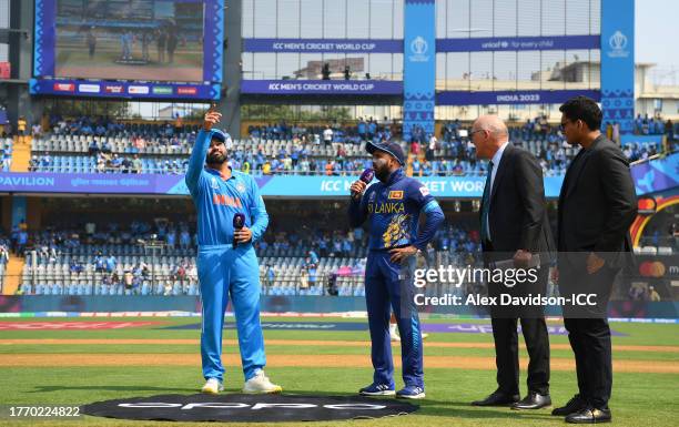 Rohit Sharma of India flips the coin as Kusal Mendis of Sri Lanka looks on ahead of during the ICC Men's Cricket World Cup India 2023 between India...
