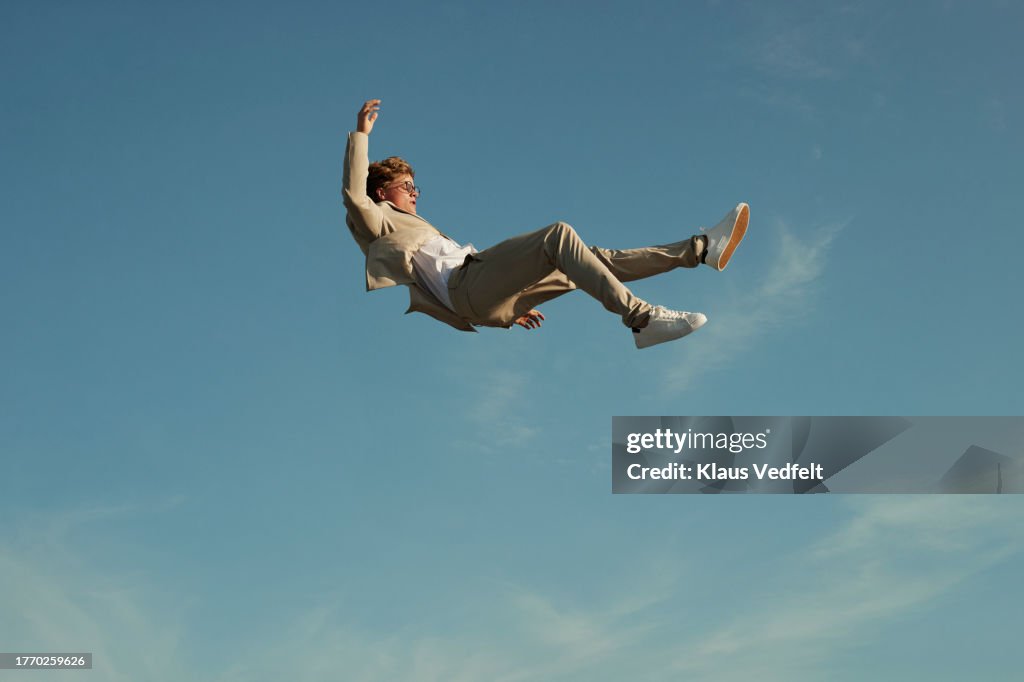 Young man levitating while doing acrobats