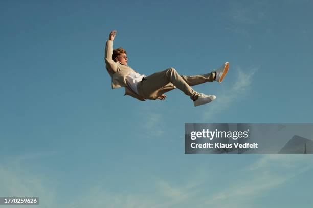 young man levitating while doing acrobats - traumhaft stock-fotos und bilder