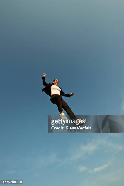 young woman falling from blue sky - black high heels stock pictures, royalty-free photos & images