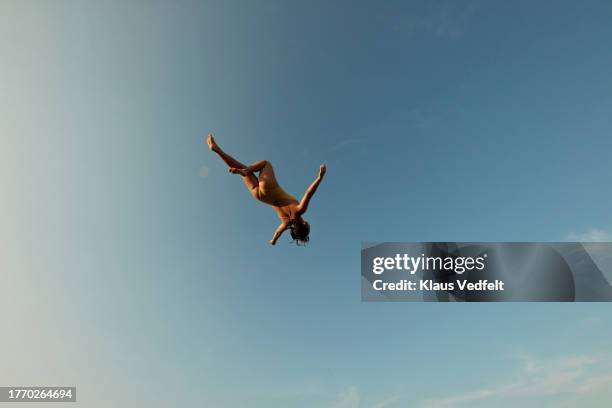 woman levitating high up in mid air - sous vêtement photos et images de collection