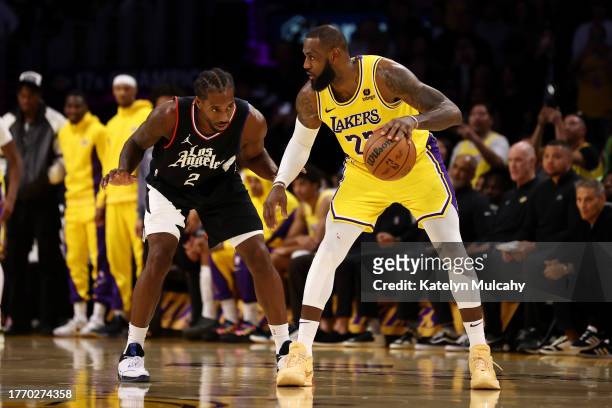LeBron James of the Los Angeles Lakers dribbles the ball against Kawhi Leonard of the Los Angeles Clippers during the fourth quarter at Crypto.com...