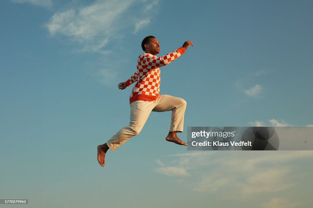 Smiling man levitating in mid-air