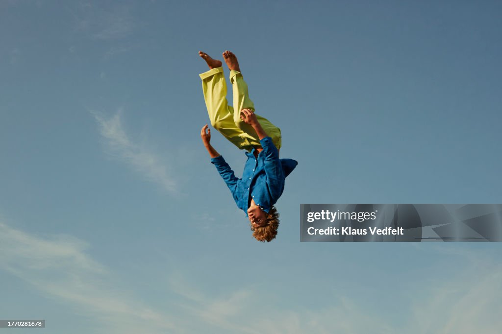 Man levitating upside down in mid-air