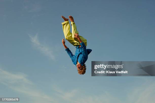 man levitating upside down in mid-air - man upside down stock pictures, royalty-free photos & images