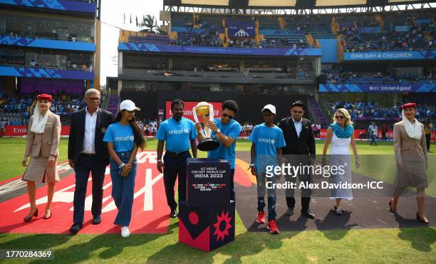Sachin Tendulkar carries the ICC Men's Cricket World Cup Trophy alongside Muttiah Muralitharan, Mr Jay Shah, BCCI Honorary Secretary, Mr Roger Binny,...