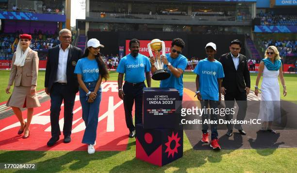 Sachin Tendulkar carries the ICC Men's Cricket World Cup Trophy alongside Muttiah Muralitharan, Mr Jay Shah, BCCI Honorary Secretary, Mr Roger Binny,...