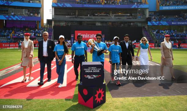 Sachin Tendulkar carries the ICC Men's Cricket World Cup Trophy alongside Muttiah Muralitharan, Mr Jay Shah, BCCI Honorary Secretary, Mr Roger Binny,...