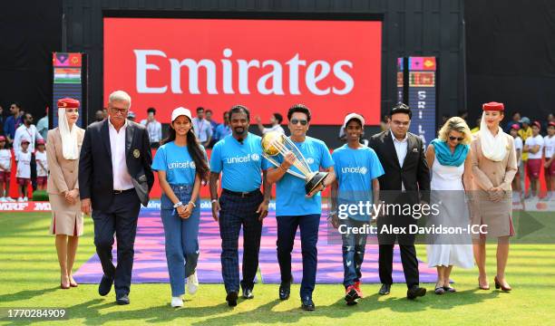 Sachin Tendulkar carries the ICC Men's Cricket World Cup Trophy alongside Muttiah Muralitharan, Mr Jay Shah, BCCI Honorary Secretary, Mr Roger Binny,...