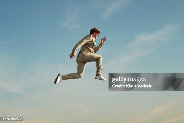 man posing mid-air against sky - person falling forward stock pictures, royalty-free photos & images