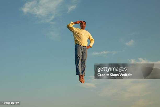 man with hand on hip saluting in mid-air - leap of faith stock pictures, royalty-free photos & images