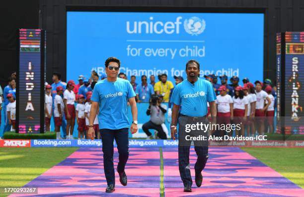Sachin Tendulkar and Muttiah Muralitharan make their way out for the National Anthems ahead of the ICC Men's Cricket World Cup India 2023 between...