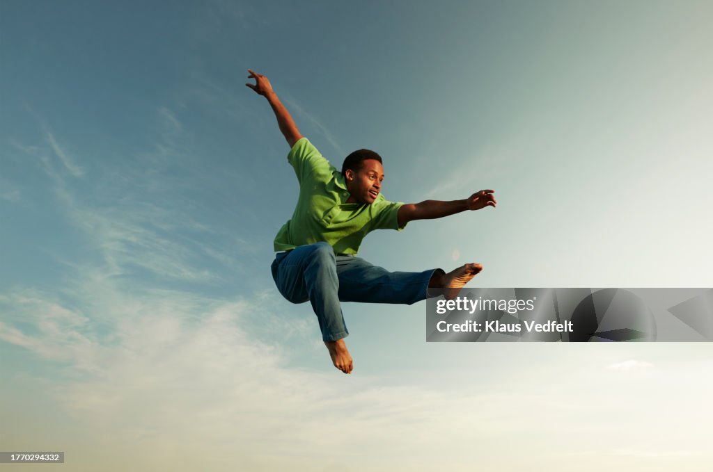 Man doing gymnastics in mid-air