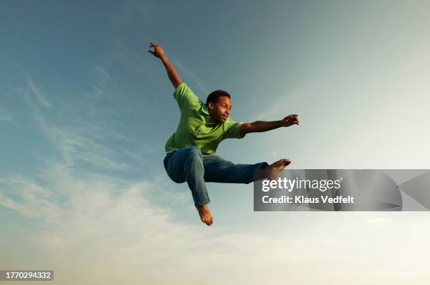 man doing gymnastics in mid-air - leap of faith stock pictures, royalty-free photos & images