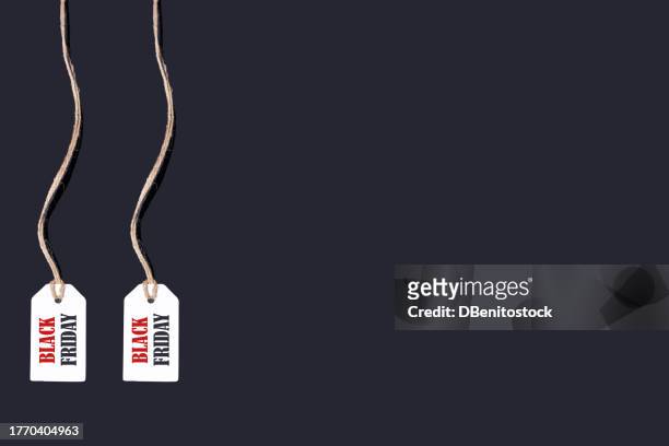 a white tag with string hanging on the left, on a black background that says: 'black friday', in red and black letters. black friday, offers, promotion, cheap prices, sales and consumerism. - f��retag bildbanksfoton och bilder