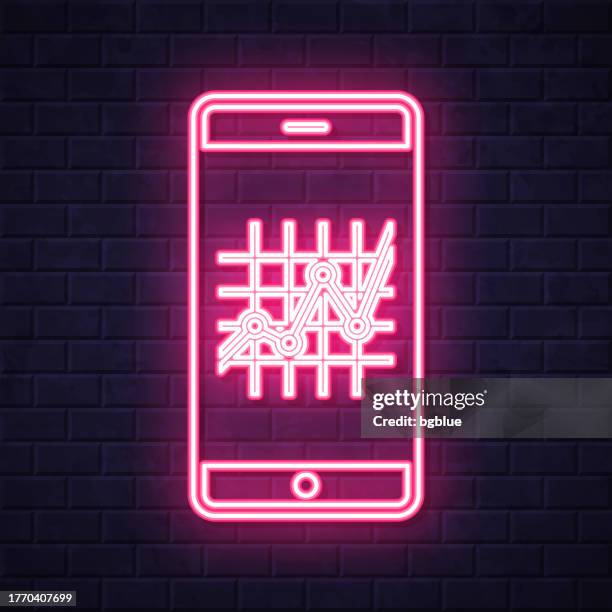smartphone with graph. glowing neon icon on brick wall background - measure wall stock illustrations