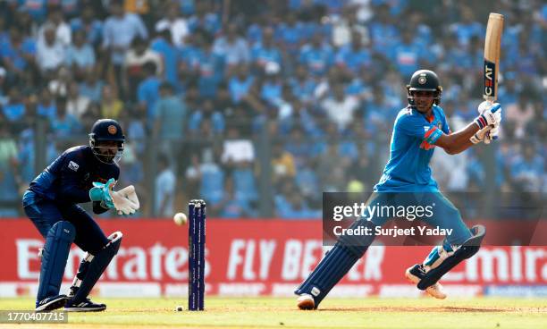 Shubman Gill of India plays a shot as Kusal Mendis of Sri Lanka keeps during the ICC Men's Cricket World Cup India 2023 between India and Sri Lanka...