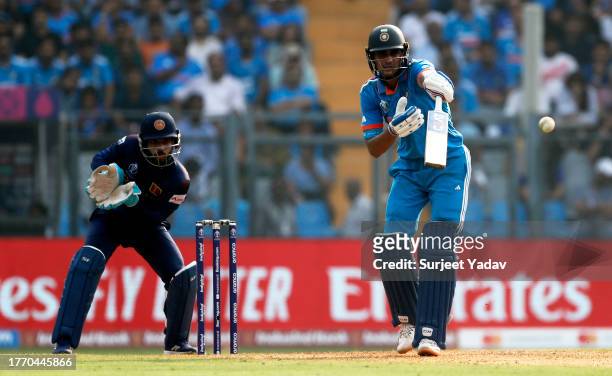 Shubman Gill of India plays a shot as Kusal Mendis of Sri Lanka keeps during the ICC Men's Cricket World Cup India 2023 between India and Sri Lanka...