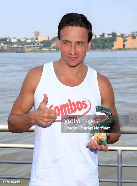 Ryan Lochte delivers Pizzeria Pretzel Combos to fans at Midtown Ferry Terminal on August 20, 2013 in New York City.