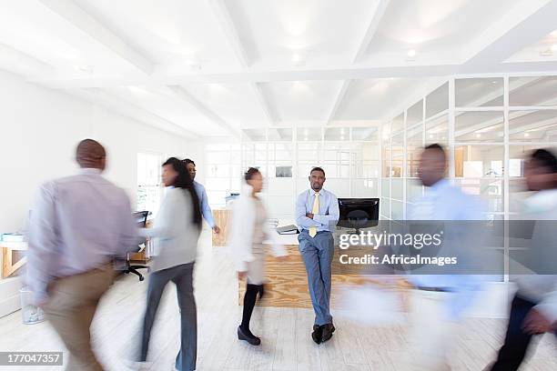 work colleagues walking around their office, africa - bustling office stock pictures, royalty-free photos & images