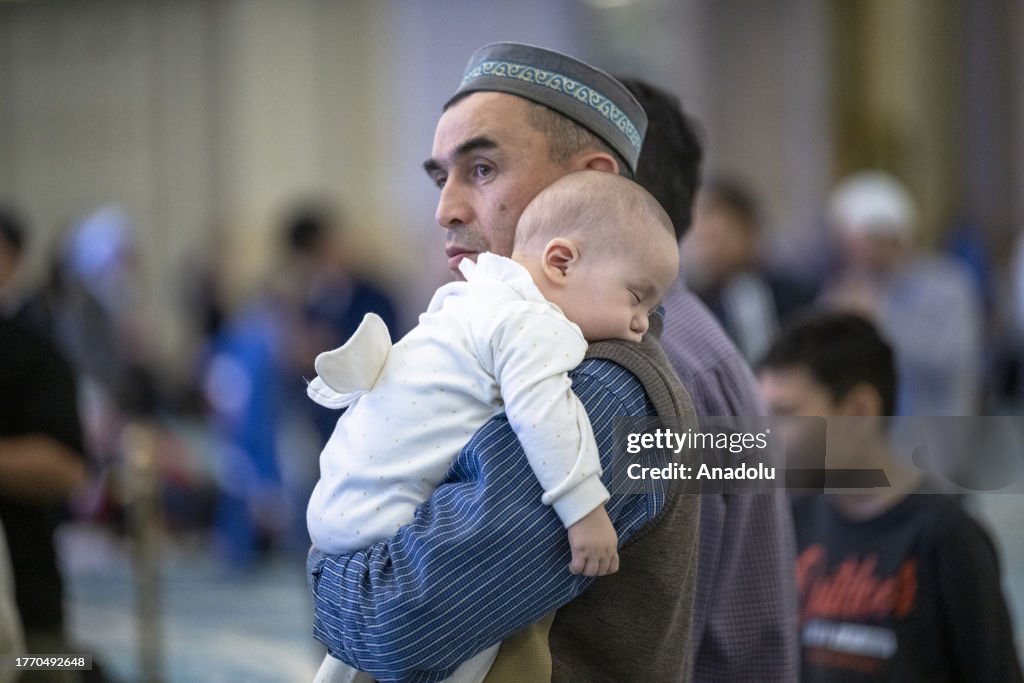 Xxdf A man holds a baby in his arms at Astana Grand Mosque in Kazakhstan ...
