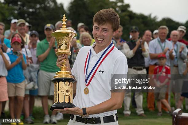 Matt Fitzpatrick from England, holds the winner's trophy after he defeated Oliver Goss from Australia by three strokes, during the final round of the...