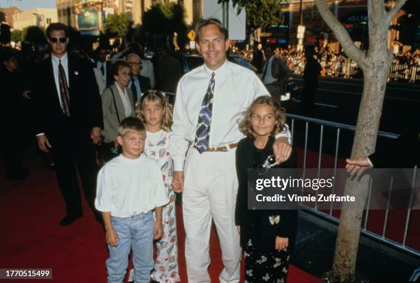 Kevin Costner, with his children Lily Costner, Joe Costner, and Annie Costner, and guests attend the Los Angeles premiere of "Waterworld", held at...